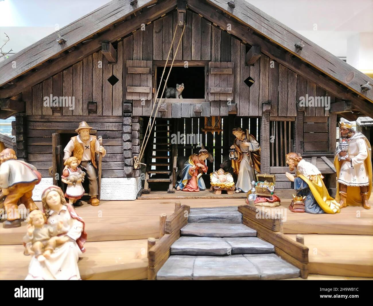 Traditional Christmas nativity scene with beautiful figures made out of wood. The birth of Jesus Christ in the manger surrounded by Joseph, Mary and t Stock Photo
