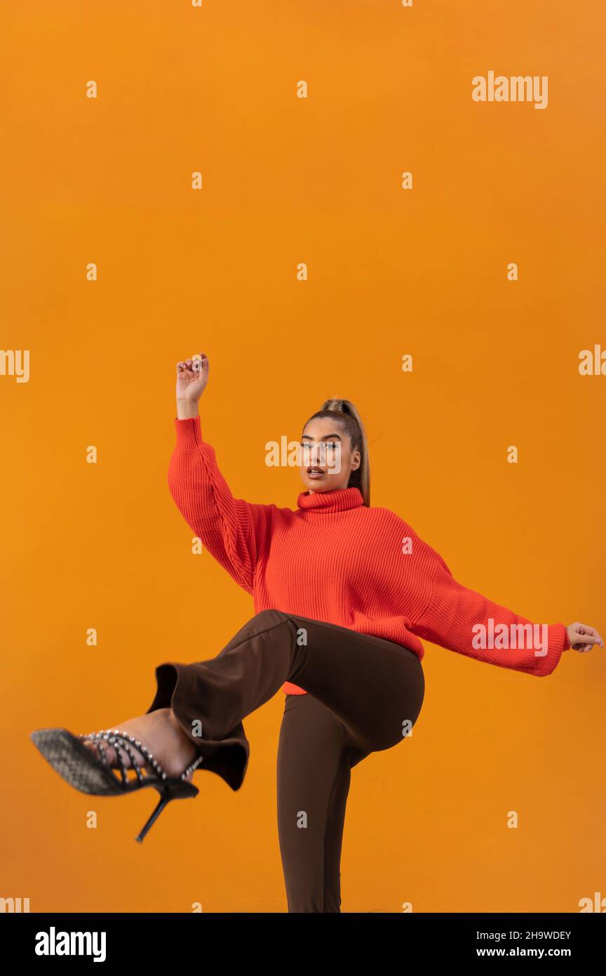 Vertical shot of a young Spanish female in a fighting pose in the