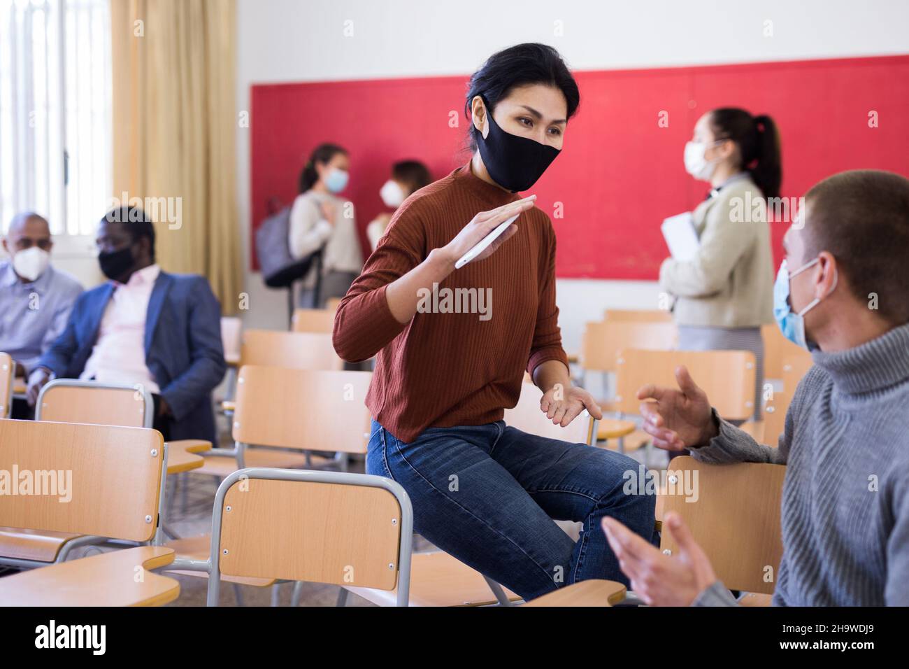 Students wearing protective mask in classroom Stock Photo