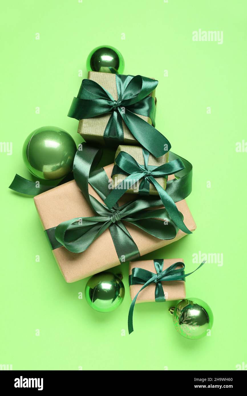 Christmas gifts and beautiful decorations on green background Stock