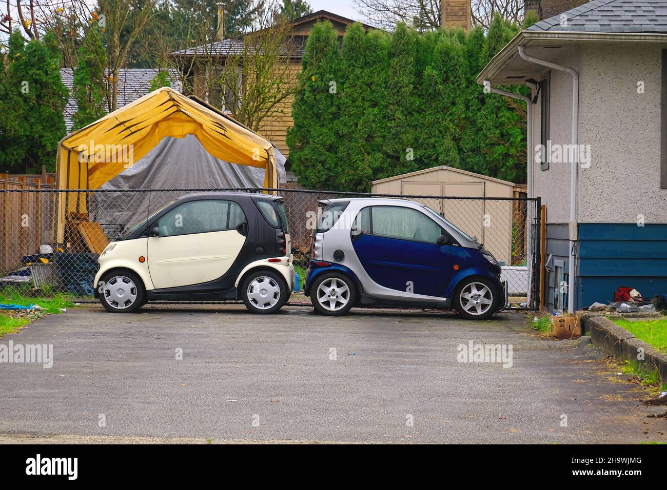 Two Smart cars parked back-to-back at a private residence. Lower Mainland, Canada. Stock Photo