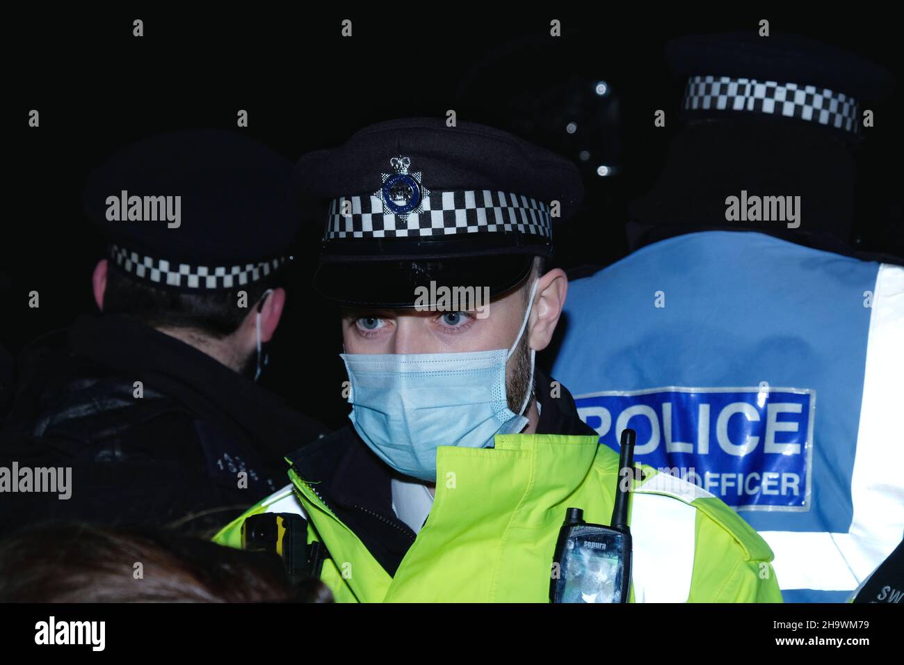 London, UK, 8th Dec, 2021, A police officer wears a facemask at a 'Kill the Bill' protest in Westminster, as the third reading of the Police, Crime, Sentencing and Courts Bill (PCSC) got underway in the House of Lords. Cases of the newly discovered Omicron variant continue to rise in the UK The new legislation, if passed, will grant police additional powers to crack-down on protest by allowing stop-and-search, data sharing of activists details and the breaking-up of demonstrations deemed as causing 'serious annoyance'. Credit: Eleventh Hour Photography/Alamy Live News Stock Photo