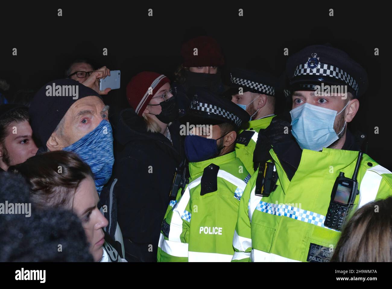 London, UK, 8th Dec, 2021, 'Kill the Bill' protesters and police officers wear facemasks as newly discovered Omricon variant poses a risk as cases increase in the UK. Facemasks in indoor settings becomes mandatory from Friday. The third reading of the Police, Crime, Sentencing and Courts Bill (PCSC) was underway in the House of Lords. The new legislation, if passed, will grant police additional powers to crack-down on protest by allowing stop-and-search and the breaking-up of demonstrations deemed as causing 'serious annoyance'. Credit: Eleventh Hour Photography/Alamy Live News Stock Photo