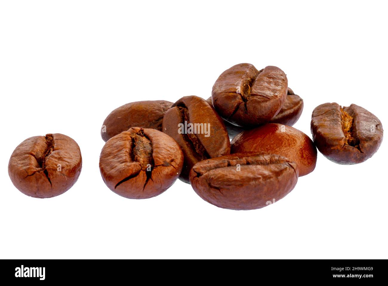 A pile of roasted coffee beans, fresh brown in color, ready to be