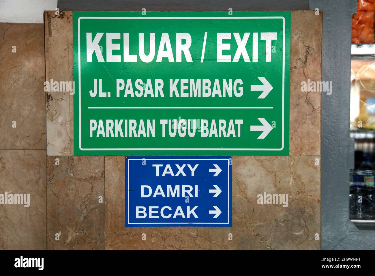 A sign at the exit of Yogyakarta train station in Central Java, Indonesia showing where to find a becak, taxi and damri bus. Stock Photo