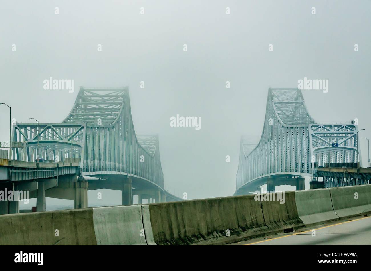 The twin bridges of the Crescent City Connection are pictured on a foggy morning, Dec. 7, 2021, in New Orleans, Louisiana. Stock Photo