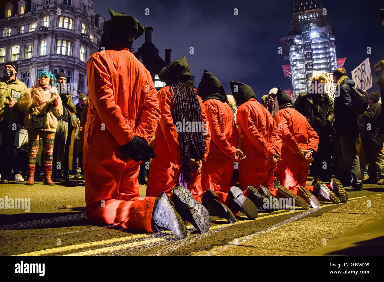 Protesters Kneel On The Ground While Wearing Wearing Prison Costumes And Masks During The 3392