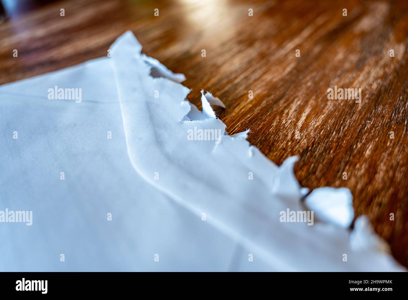 Selective focus on jagged edges of a ripped open mail envelope Stock Photo Alamy