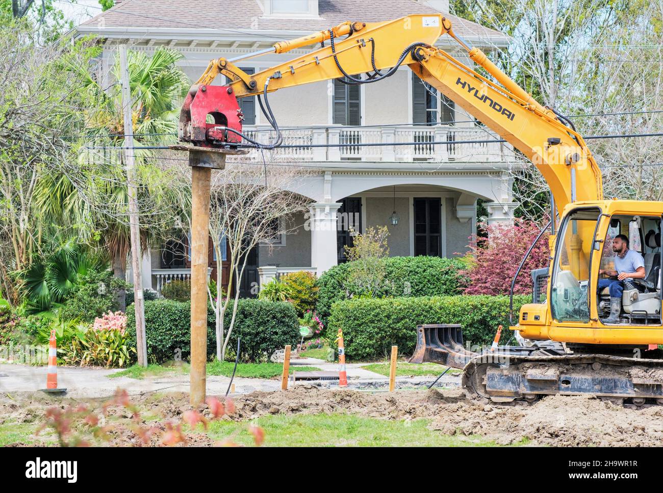 NEW ORLEANS, LA, USA - MARCH 22, 2021: Man operating pile driver for new construction in Uptown neighborhood Stock Photo