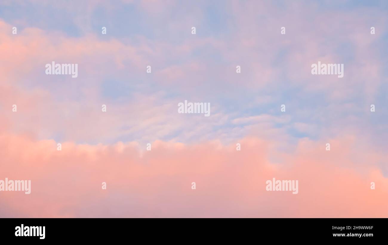 Background of blue sky with pale pink clouds in sunset Stock Photo - Alamy