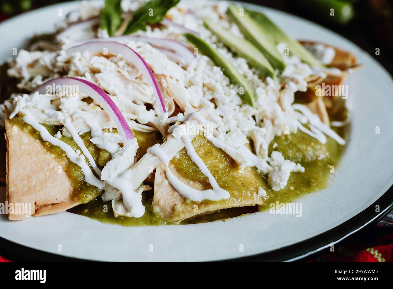 Mexican green chilaquiles with chicken and spicy green sauce traditional breakfast in Mexico