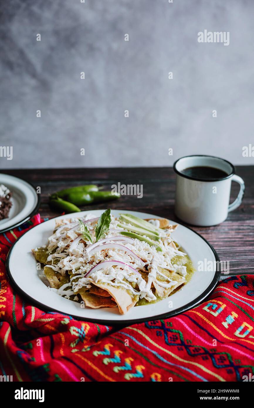 Mexican green chilaquiles with chicken and spicy green sauce traditional breakfast in Mexico