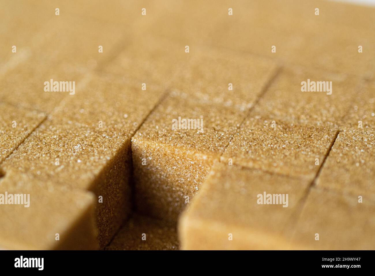 Brown sugar cubes used to sweeten drinks and beverages Stock Photo