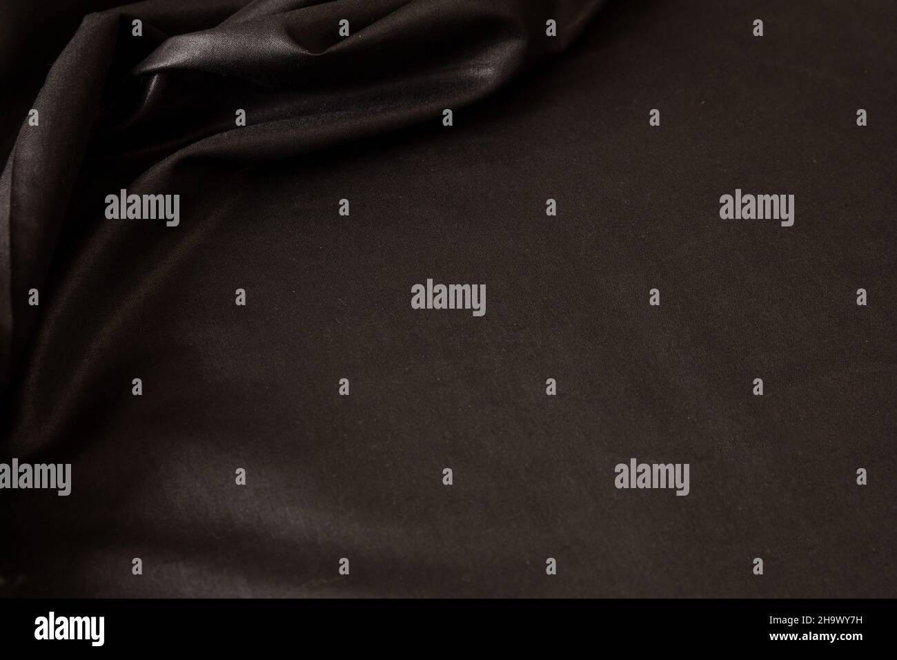 Black satin background luxury textile texture, silk cloth wave material, Christmas abstract dark backdrop, elegant shiny wallpaper template Stock Photo