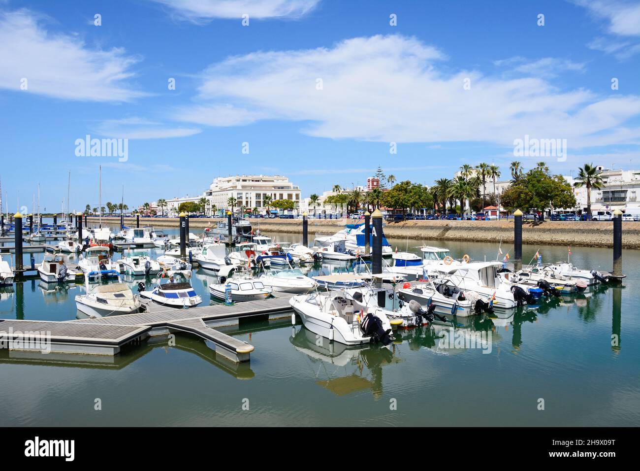 Motor boats moored in the marina (Puerto Ayamonte) with town buildings to the rear, Ayamonte, Huelva Province, Andalucia, Spain, Europe. Stock Photo