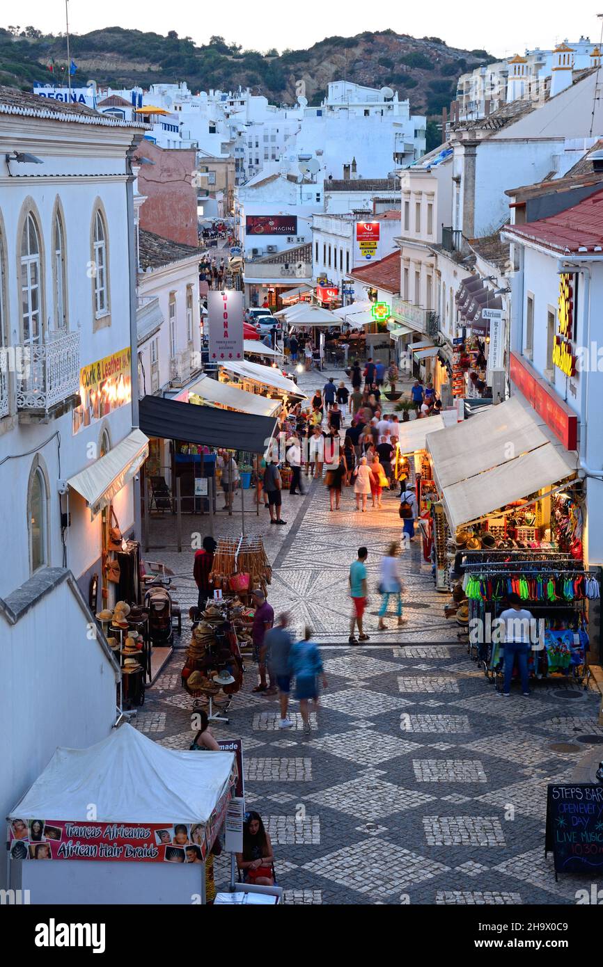 Elevated view of the R 5 de Outubro shopping street in the evening with tourists enjoying the setting, Albufeira, Portugal, Europe. Stock Photo