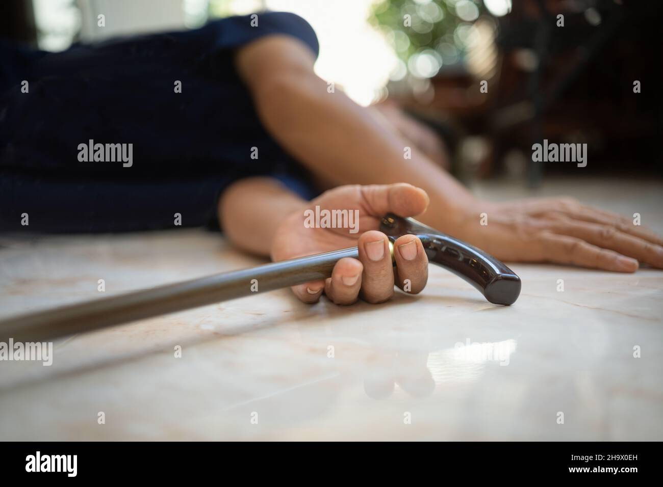 Senior man falling down at home because stumbled on a door kerb Stock Photo