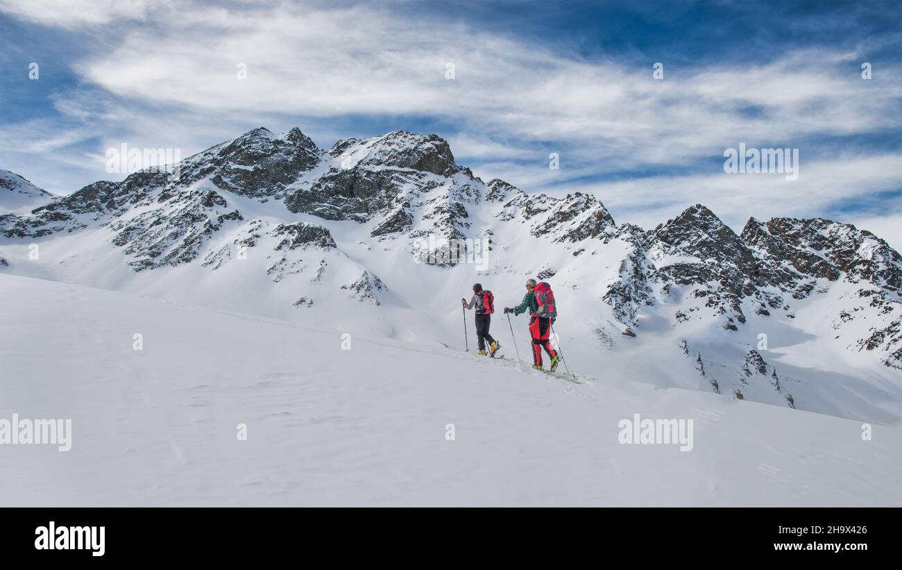 Couple of friends during a ski mountaineering excursion in the Swiss Alps Stock Photo