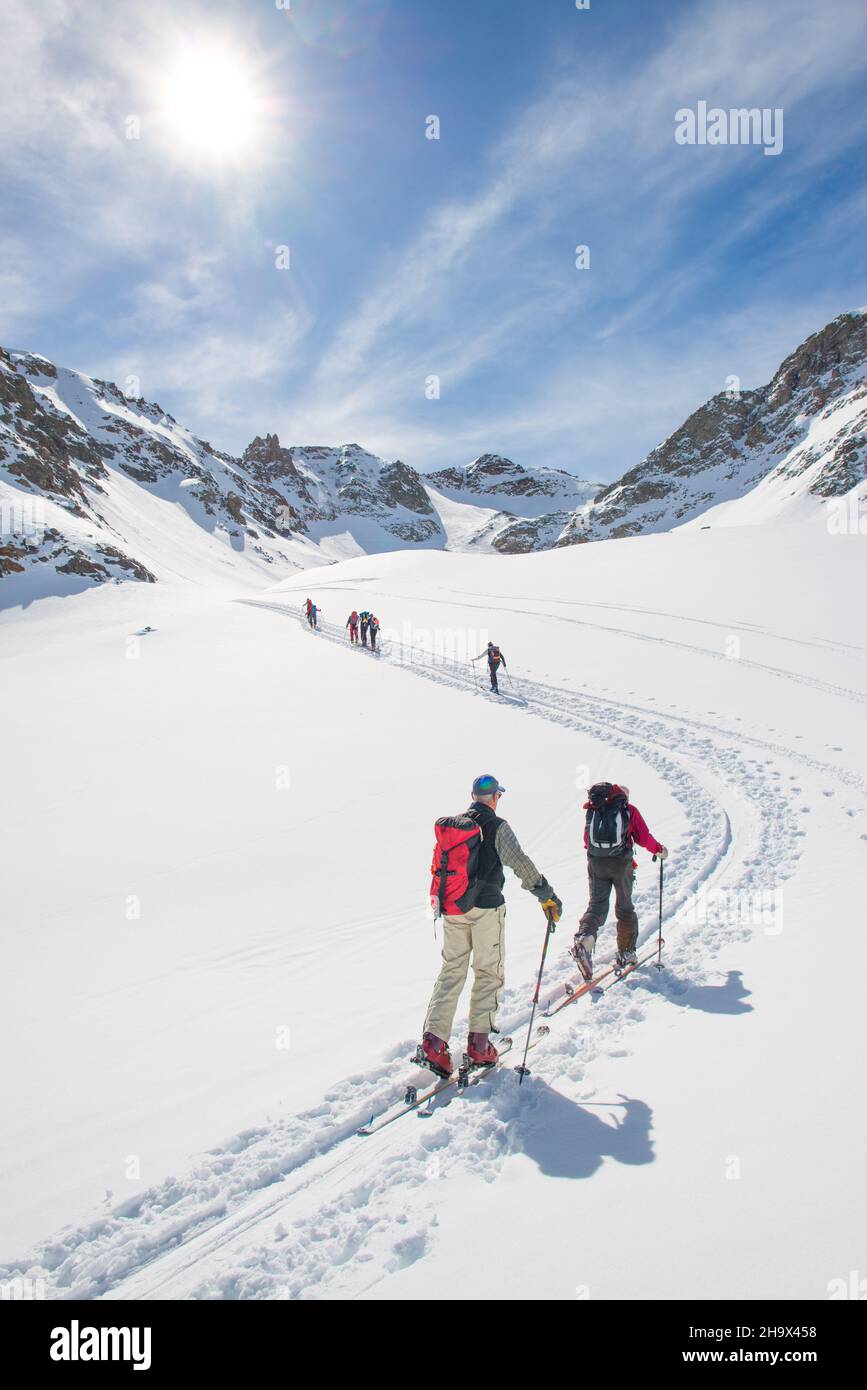 Ski mountaineering ascent track in swiss alps with people climbing Stock Photo
