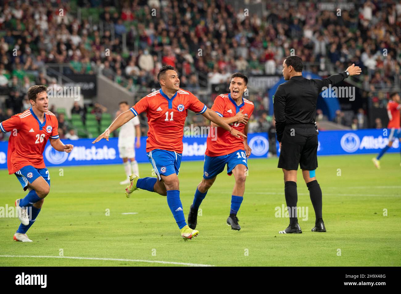 Austin, Texas, USA. 8th December, 2021. Chile's IVAN MORALES (11) is chased by teammates CLEMENTE MONTES (28) and MARCELINO NUNEZ (10) after Morales scores a goal during the first half of a Mexico National Team vs. Chile friendly at Austin's Q2 Stadium. The teams were tied, 2-2 after regulation play. Credit: Bob Daemmrich/Alamy Live News Stock Photo