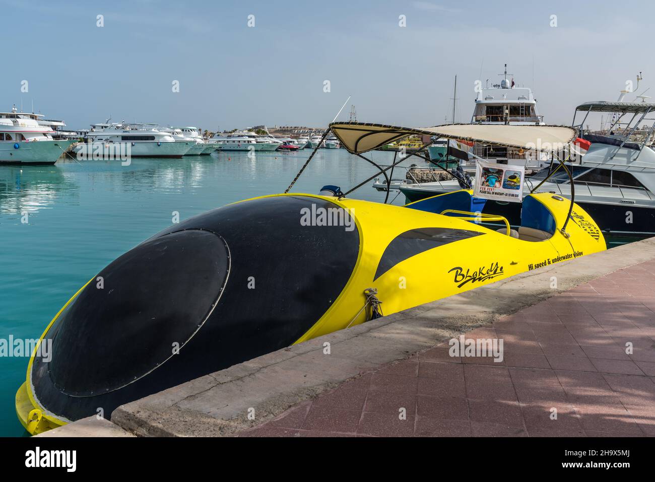 Hurghada, Egypt - May 31, 2021: The semi submarine glass speed boat at the pier of New Marina in Hurghada, popular beach resort town along Red Sea coa Stock Photo