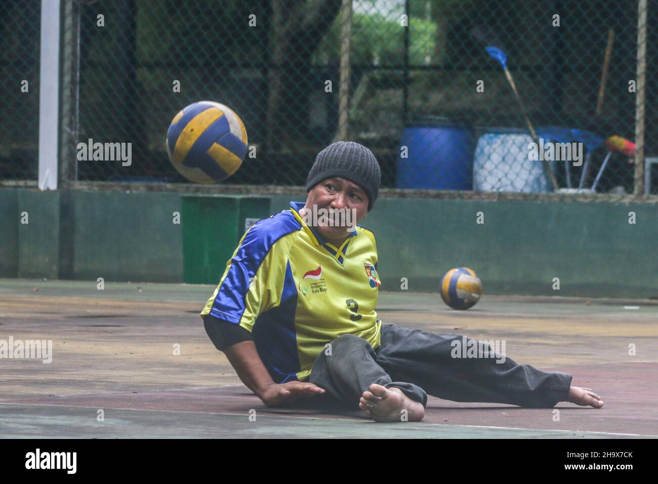 athletes with disabilities practice sitting volleyball on the indoor ...