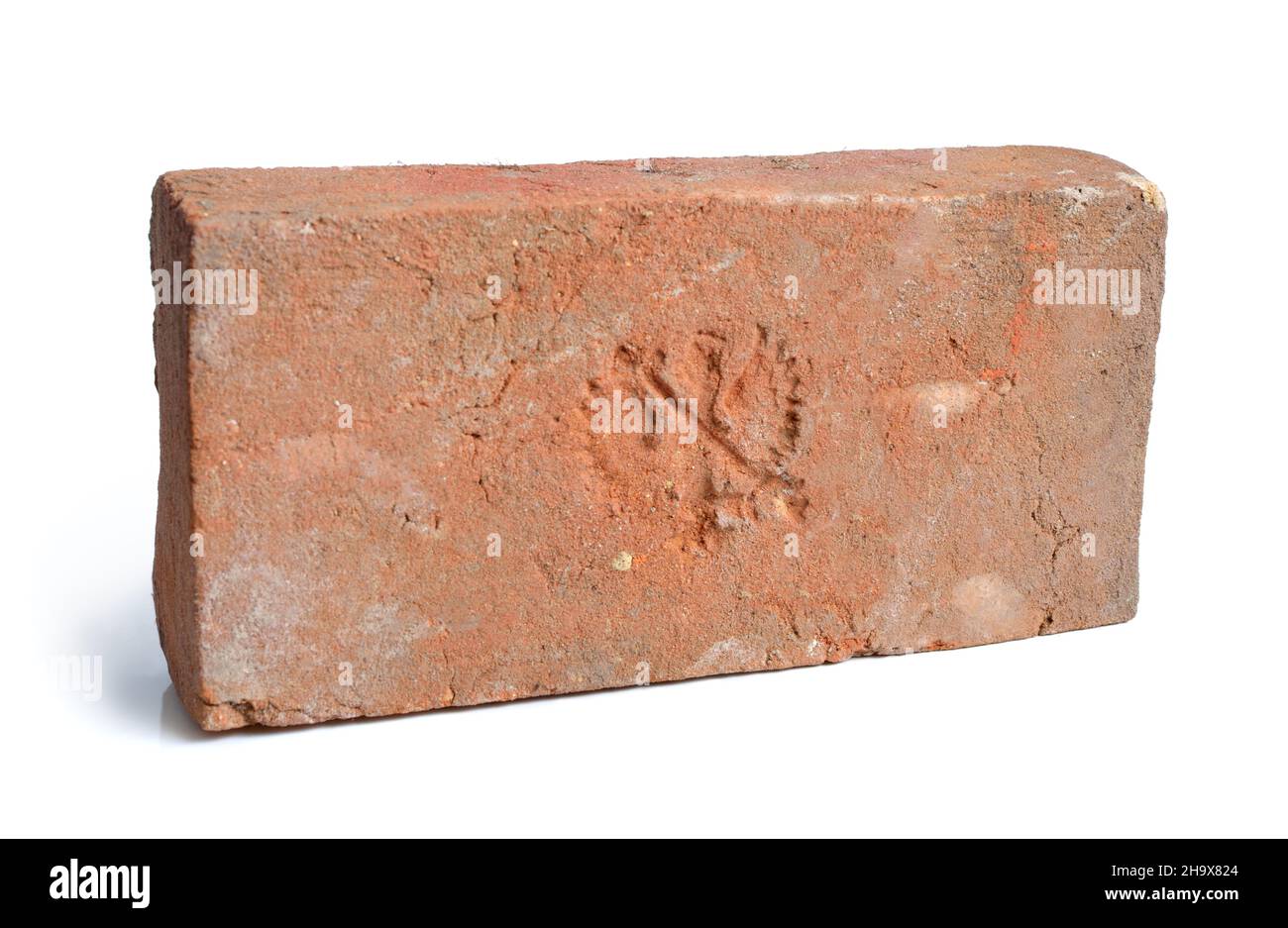 Antique brick with a stamp. Isolated. Stock Photo