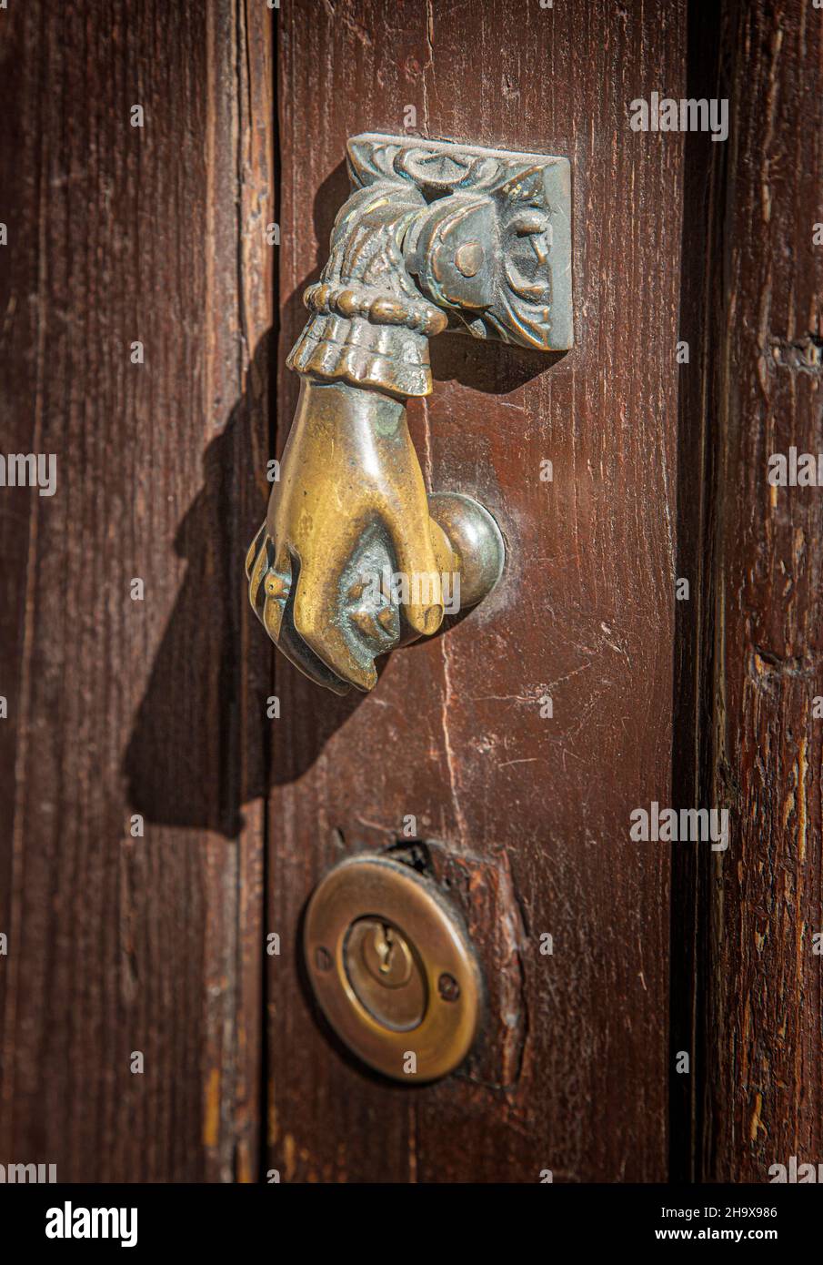 Antique hand shaped door knocker closeup Stock Photo