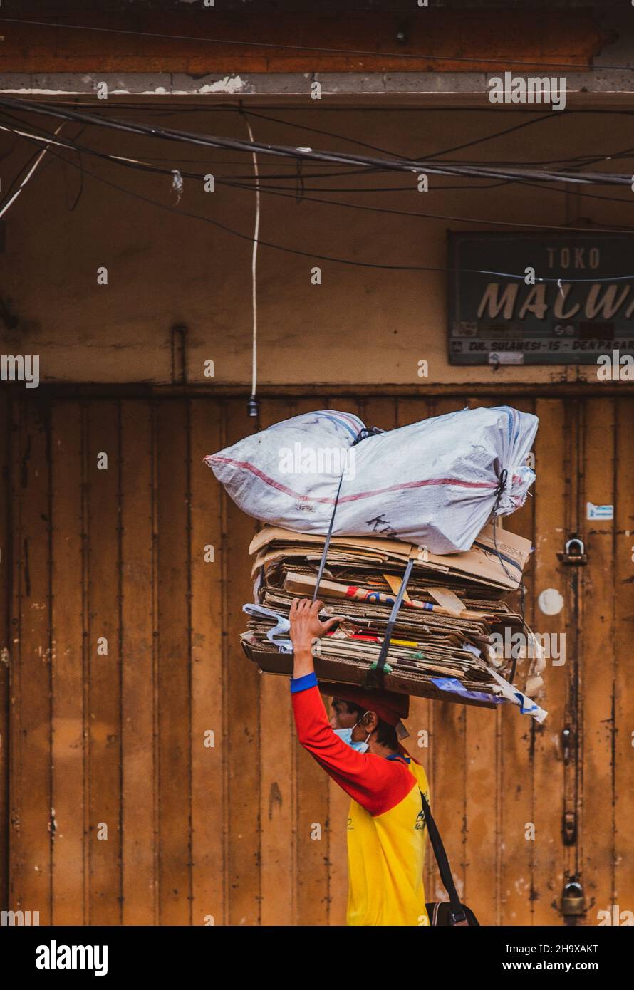 A man carrying goods on his head to be deliver Stock Photo