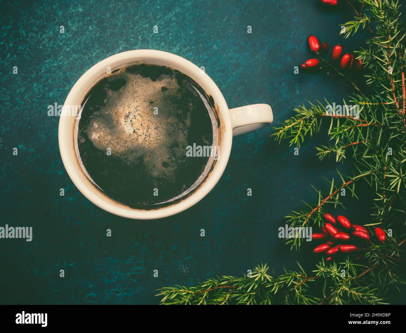 christmas background. winter composition, coffee, spruce branches and berries of barberry. New Year's holiday greeting card Stock Photo