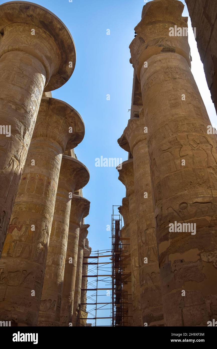Process of restoration of columns in Great Hypostyle Hall at Temples of Karnak (ancient Thebes). Ancient Egyptian hieroglyphs and symbols carved on co Stock Photo
