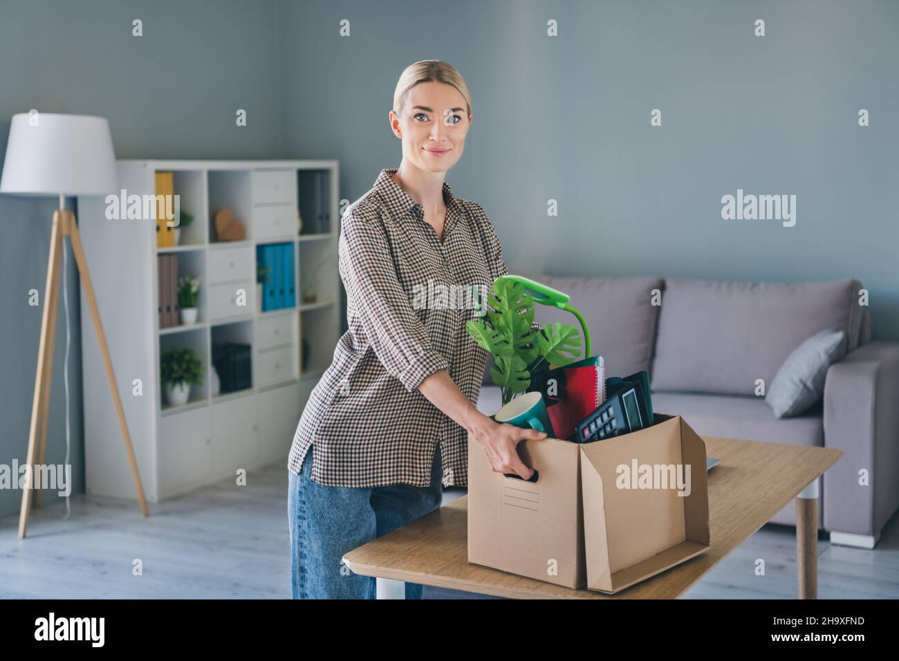 Photo of marketer agent executive lady fired hold carton box office belongings move modern workspace Stock Photo