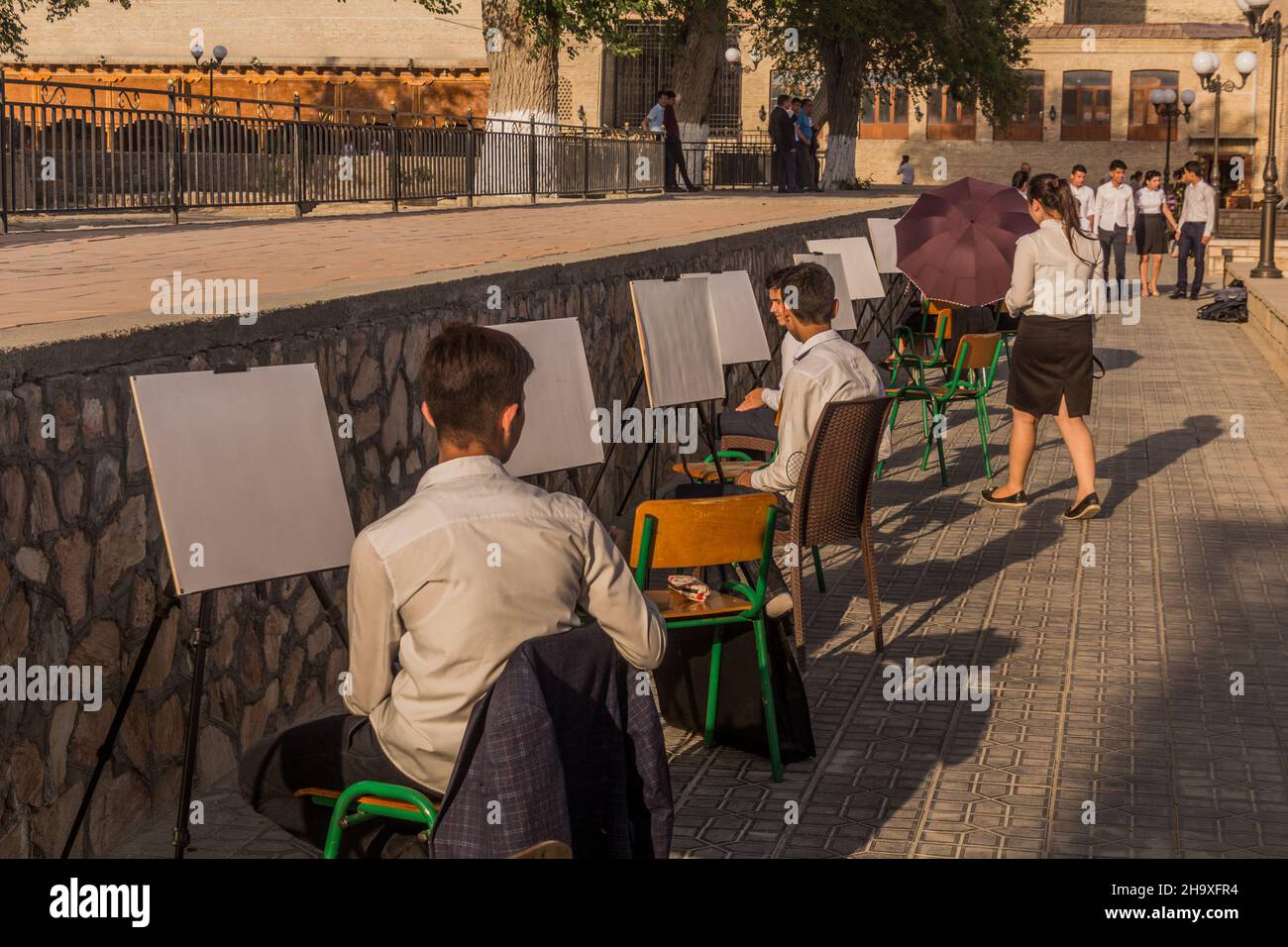 BUKHARA, UZBEKISTAN - APRIL 30, 2018: Painting students in the center of Bukhara, Uzbekistan Stock Photo