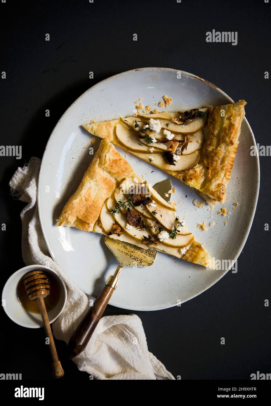 Two slices of puff pastry with pears, goat's cheese and honey (top view