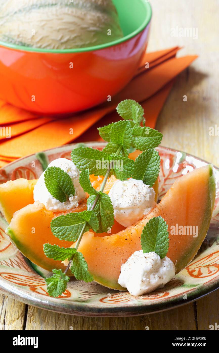 Cantaloupe melon with goat's cheese and mint Stock Photo Alamy