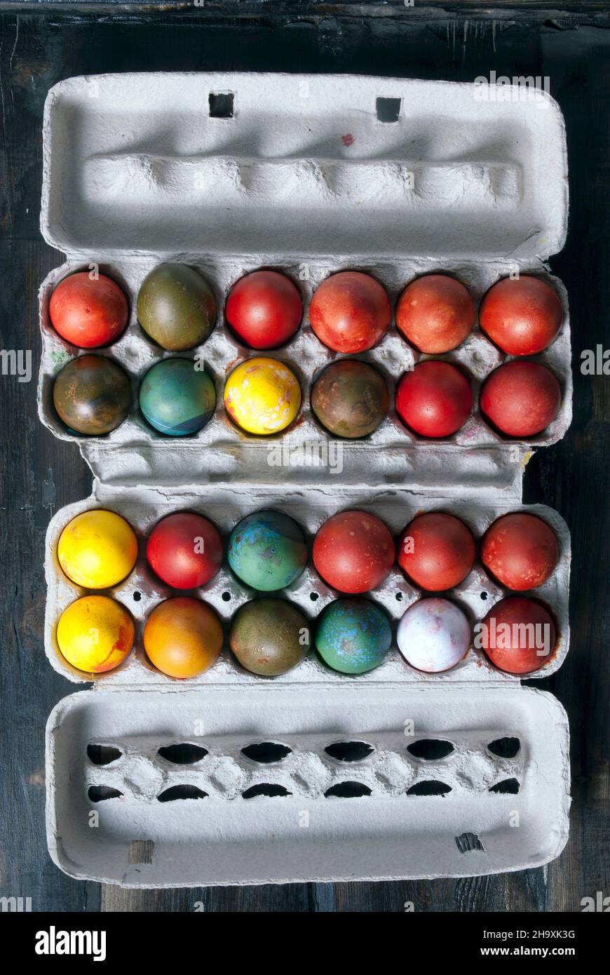 Naturally dyed eggs in an egg box for Easter Stock Photo
