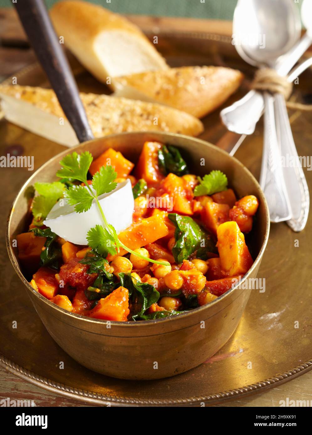 Sweet potato curry with chickpeas, cinnamon, tomato, spinach, garam
