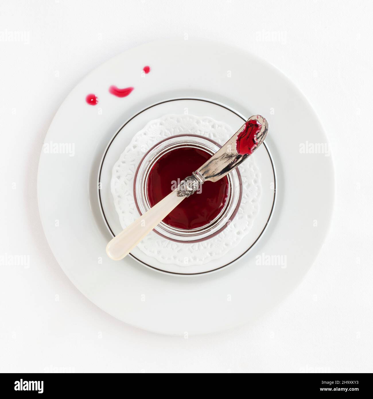 A dish of hibiscus syrup with a knife Stock Photo