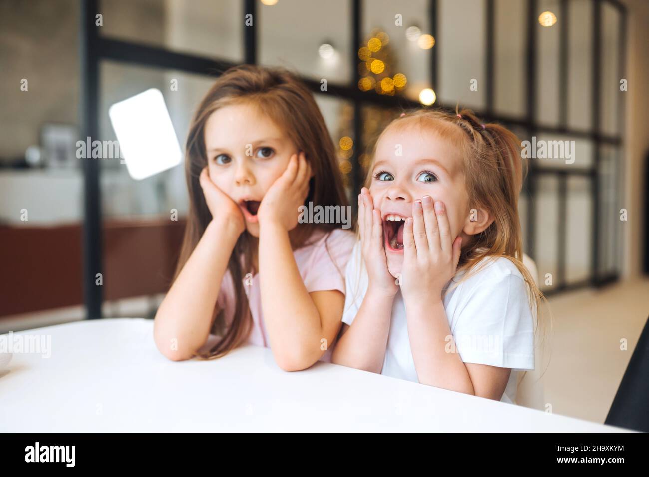 Portrait of a little amazing girls with opening mouth at home Stock Photo