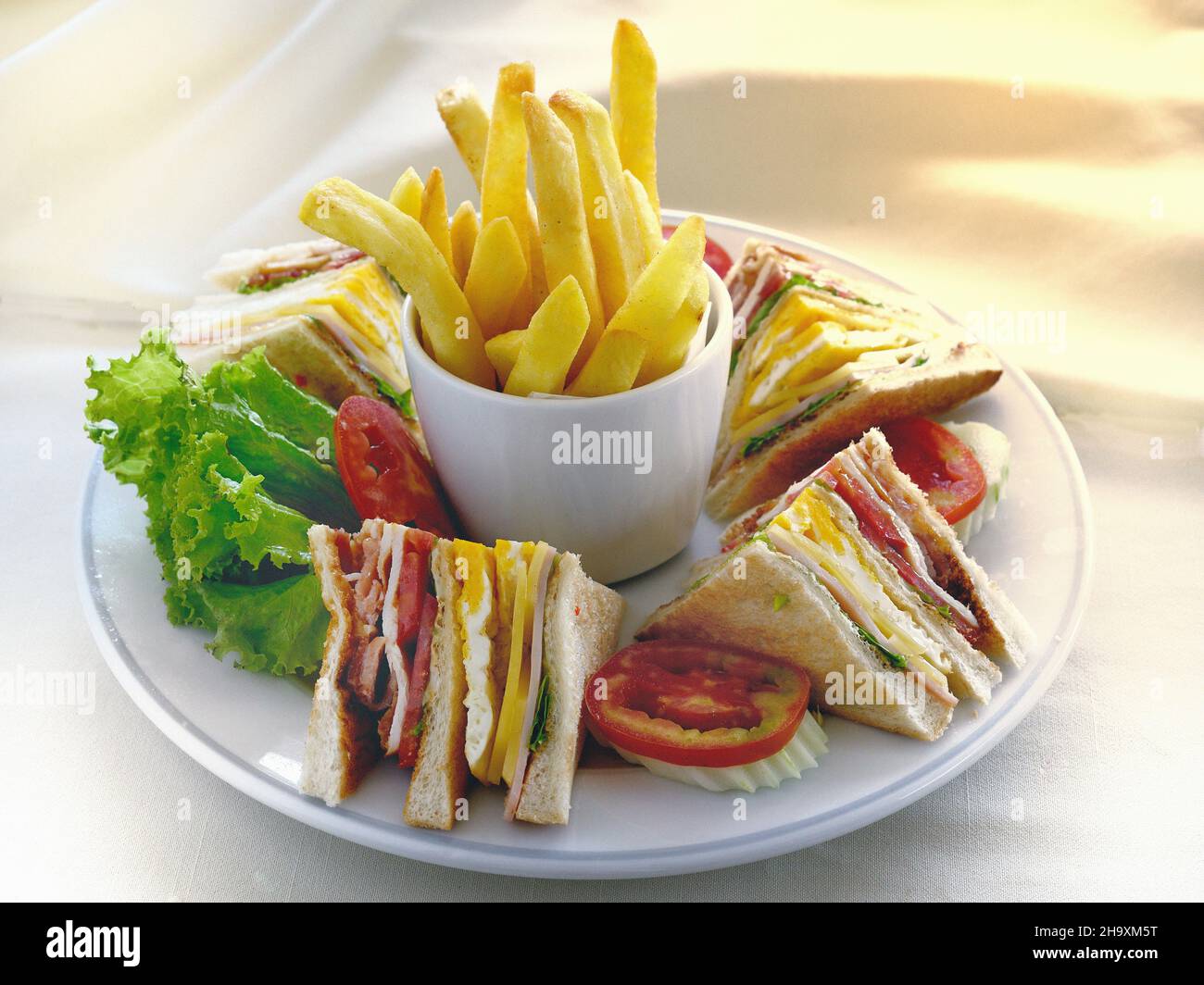 Club sandwiches with french fries Stock Photo - Alamy