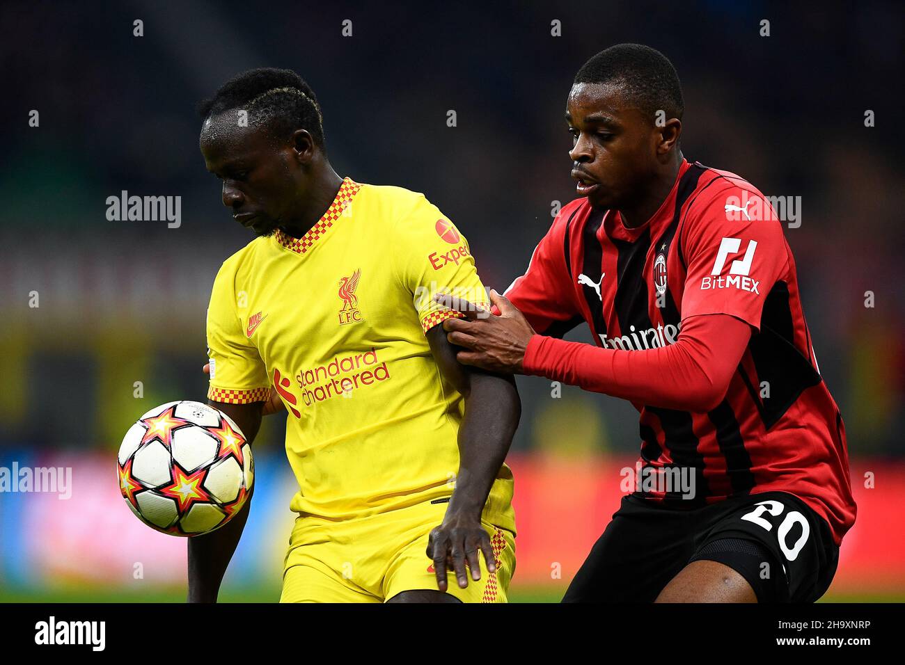 Milan, Italy. 07 December 2021. Sadio Mane of Liverpool FC is challenged by Pierre Kalulu of AC Milan during the UEFA Champions League football match between AC Milan and Liverpool FC. Credit: Nicolò Campo/Alamy Live News Stock Photo