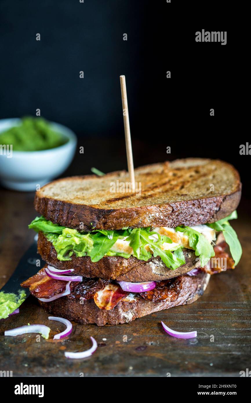 A grilled sandwich with vegetables, egg and bacon Stock Photo