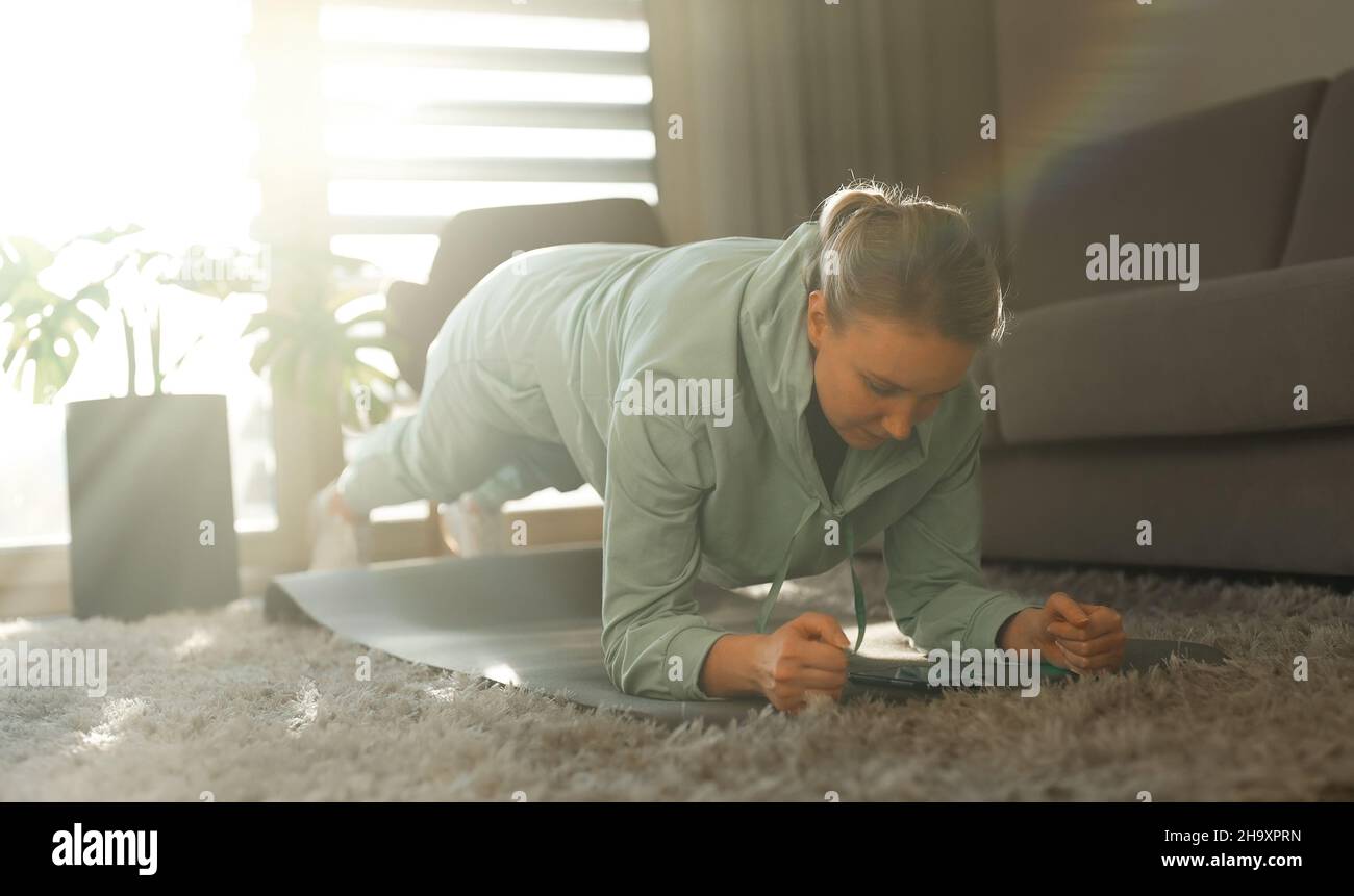 Woman doing plank exercise. Home fitness training concept. Stock Photo