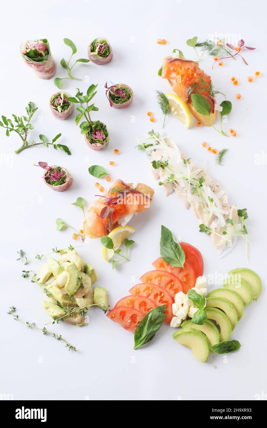 Various canapés with salmon, vegetables and herbs Stock Photo