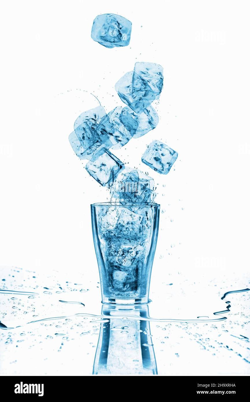 Glass of water with ice cubes around, close-up Stock Photo - Alamy