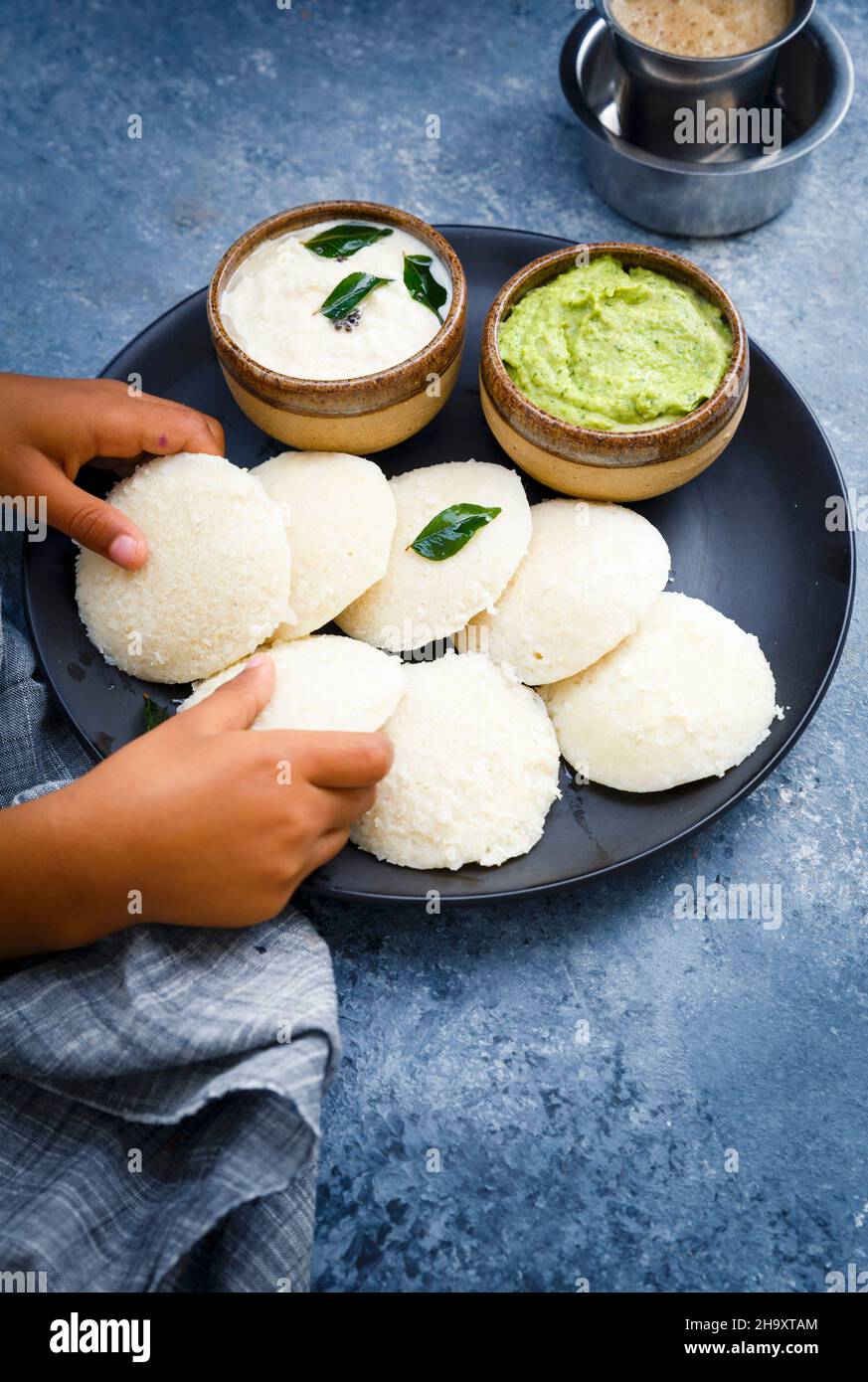 Traditional breakfast with Idli (rice cakes), coriander chutney