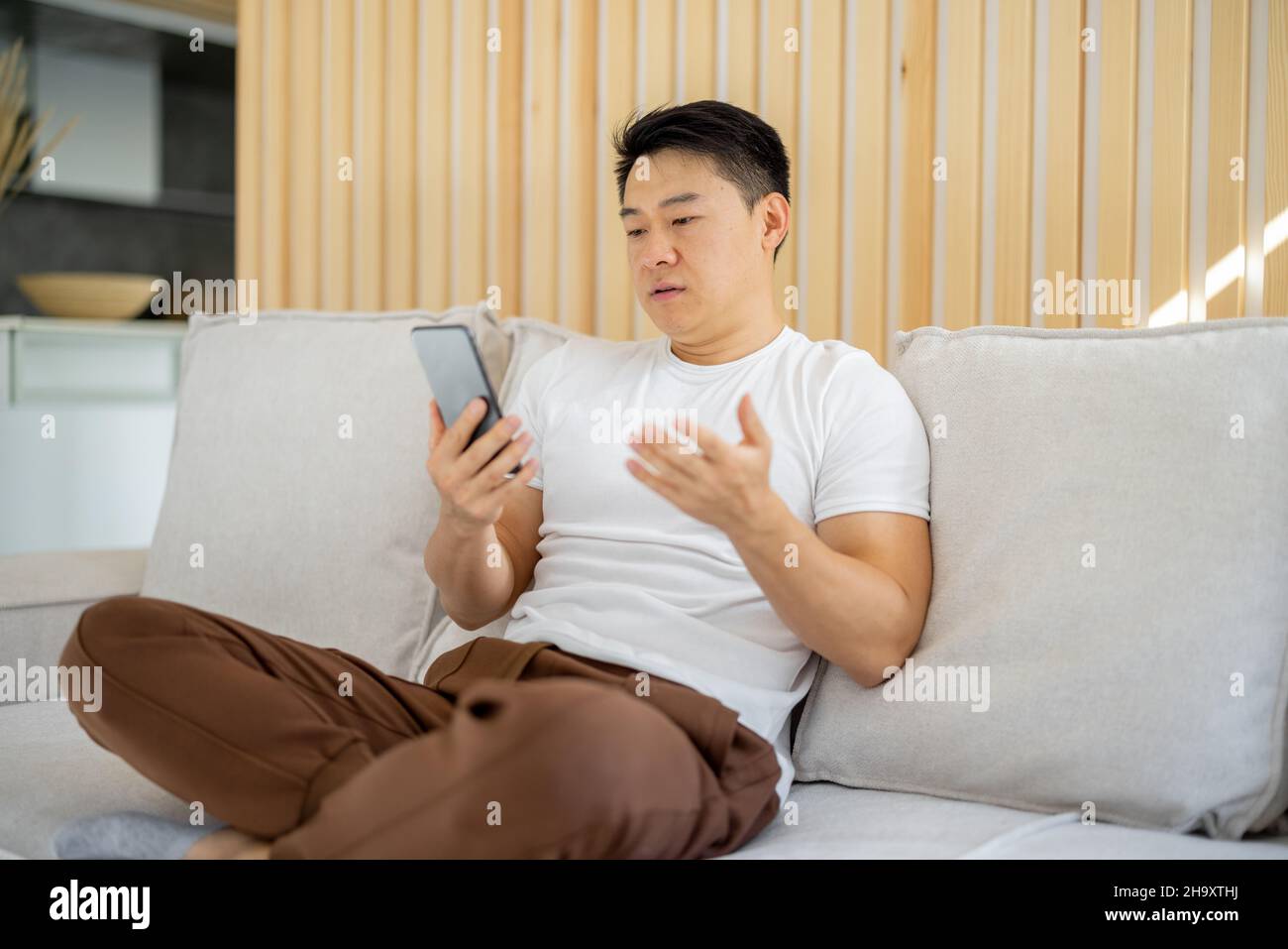 Asian man having video call on smartphone Stock Photo