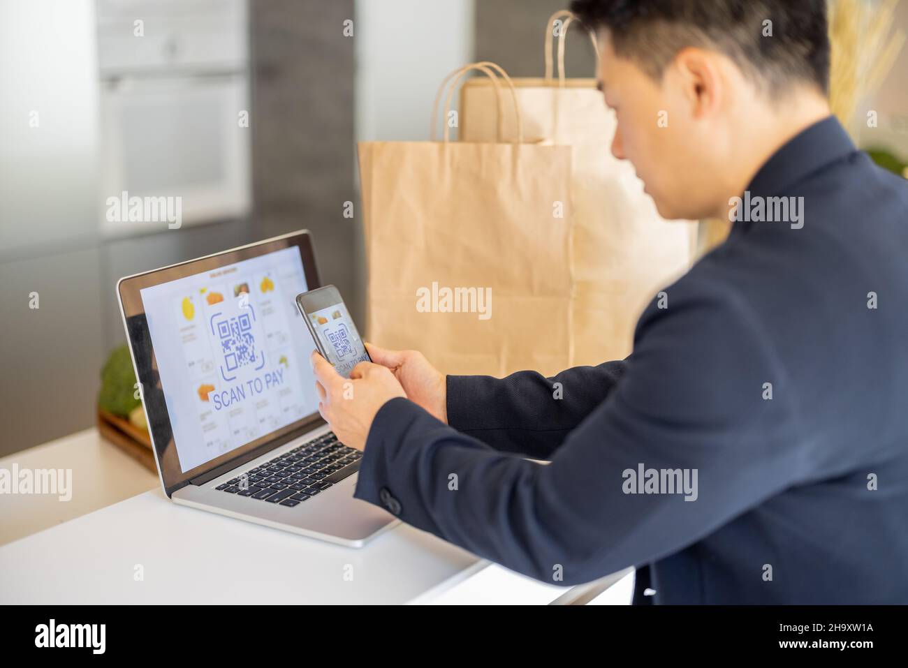 Man using smartphone for payment in online store Stock Photo