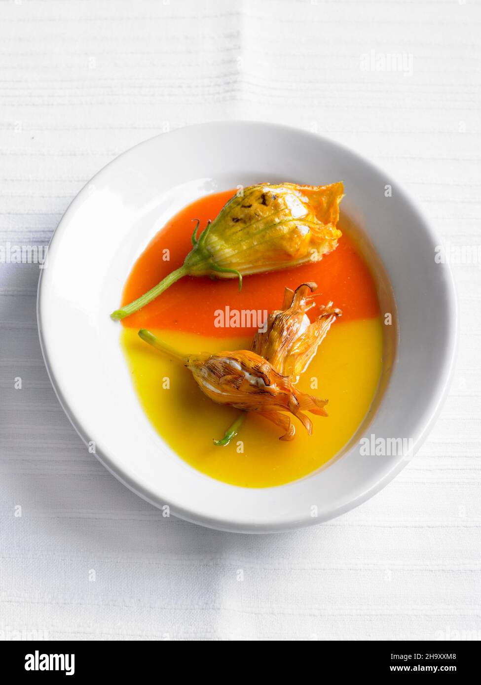 Stuffed zucchini flowers in red and yellow pepper sauce Stock Photo Alamy