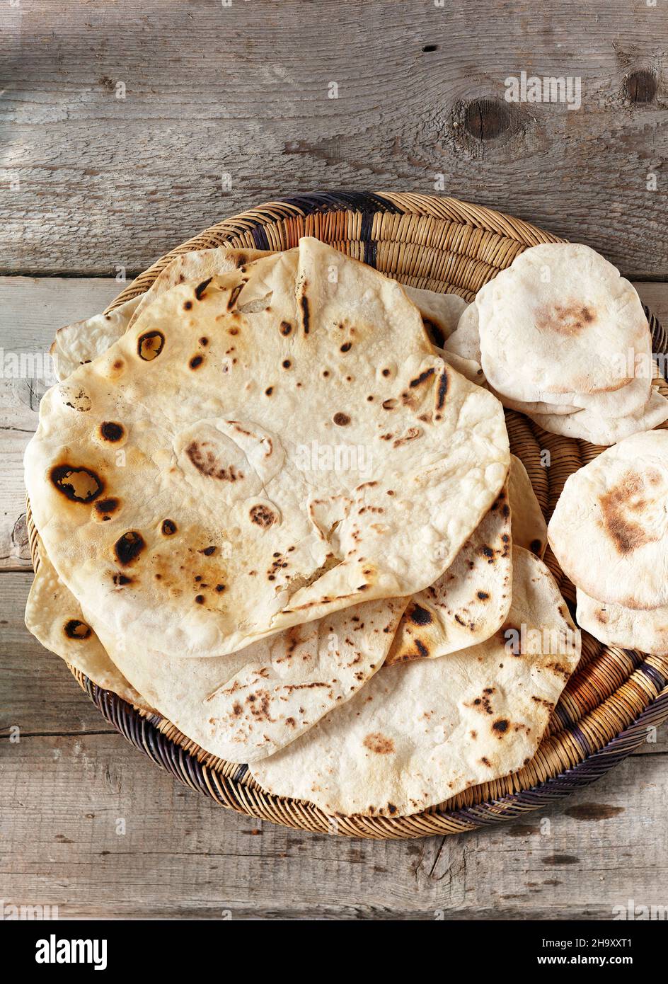 Unleavened bread (Markouk) and pita bread in a flat basket Stock Photo